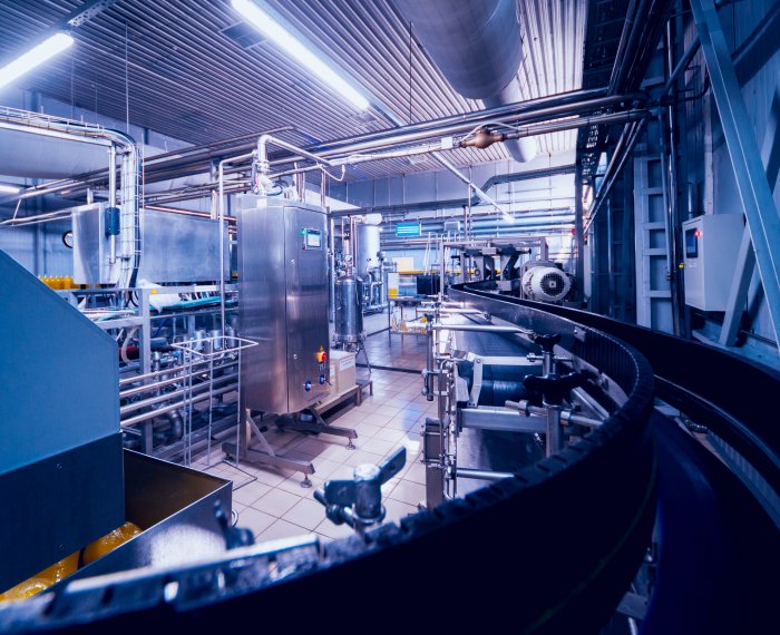 Beverage factory interior. Conveyor with bottles for juice or water. Equipments Beverage factory interior. Conveyor with bottles for juice or water. Modern equipments
