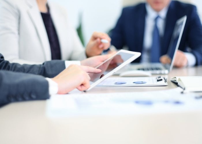 Business adviser analyzing financial figures denoting the progress in the work of the company Business adviser analyzing financial figures denoting the progress in the work of the company