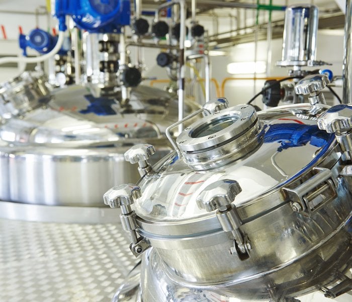 pharmaceutical industry worker pharmaceutical factory equipment mixing tank on production line in pharmacy industry manufacture factory