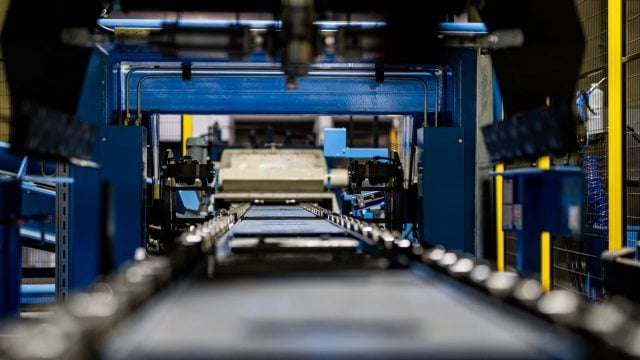 Empty Production line in factory, with yellow safety fence, conv Empty Production line in factory, with yellow safety fence, conv