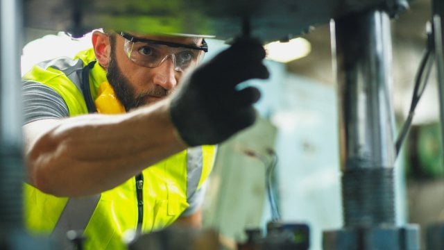 Close up hand industrial industrial plant with a tablet in hand, Close up hand industrial industrial plant with a tablet in hand, Engineer looking of working at industrial machinery setup in factory.